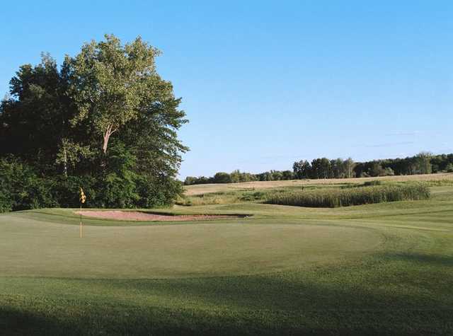 A view of a green protected by sand traps at Tanners Brook Golf Club