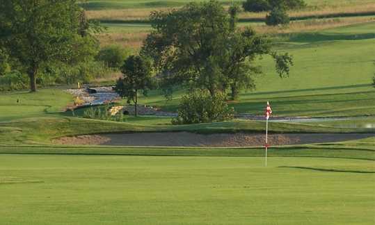 A view of a green protected by bunker at Redfield Golf & Country Club