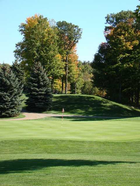 A view of a hole with cart path in background at Heather Hills Golf Club