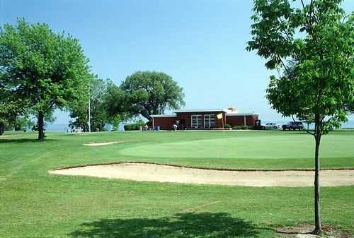 A view of the clubhouse with green in foreground at Shoop Park Golf Course