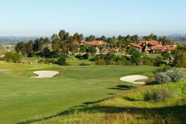 A view of a green guarded by bunkers at Santaluz Club