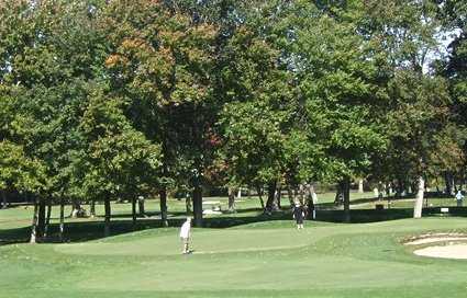A view of green guarded by bunkers at Wayland Country Club
