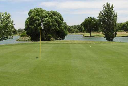 A view of a green with water coming into play at Country Club of Green Valley