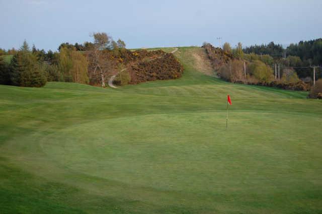 A fall view of a green at Alness Golf Club.