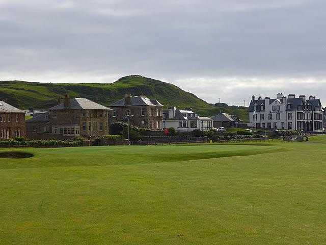A view of the clubhouse with Championship Course 18th green in foreground at Machrihanish Golf Club