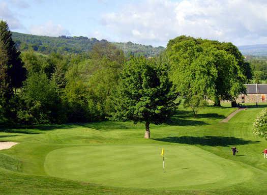 A view of a green with bunker on the left side at Cochrane Castle Golf Club.