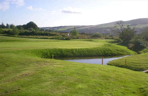 A view of a hole with water on the right side at Vale of Leven Golf Club