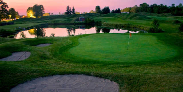 A view of a green guarded by sand traps at Missing Links Golf Course
