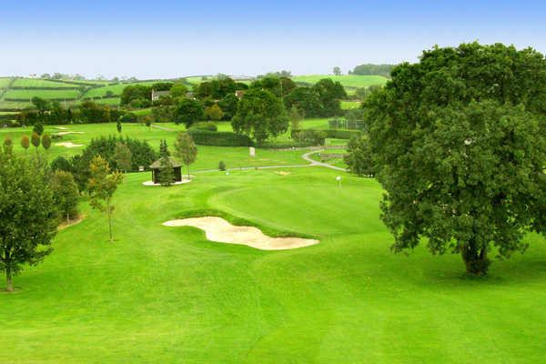 A view of hole #8 guarded by bunker at Rockmount Golf Club