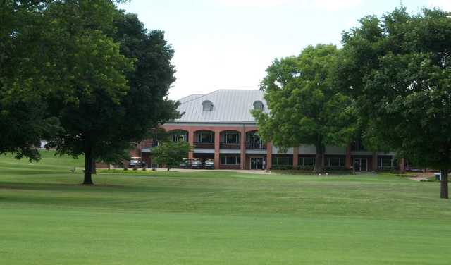 A view of the clubhouse and practice putting green at Huntsville Country Club