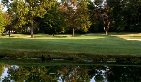 A view of a green surrounded by water at Huntsville Country Club