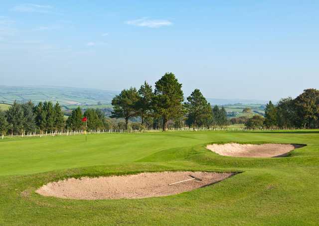 A view of a green protected by bunkers at Carmarthen Golf Club
