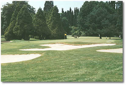 Eastmoreland #9: Hole #9 is the second longest par 5 on the course. Trees and shrubs line the fairway from the tee to a green that is well protected by one bunker to the left-front and three to the right-front