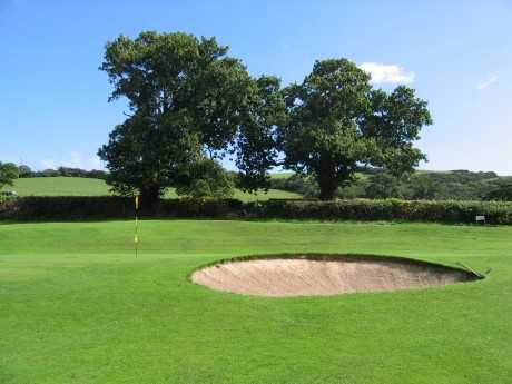 A view of a hole protected by bunker at Old Colwyn Golf Club
