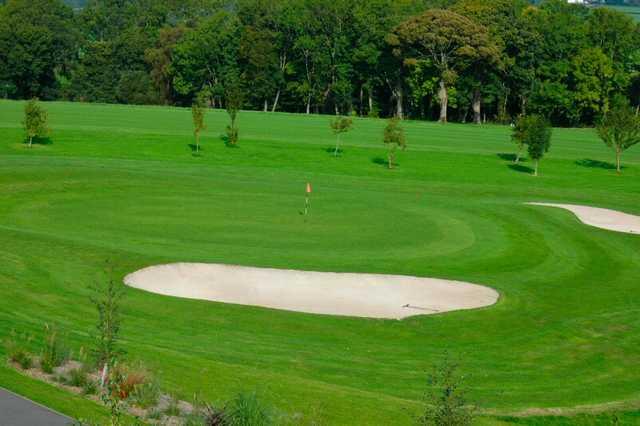 A view of a green protected by sand traps at Henllys Golf Club.