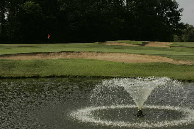 A view of green with water fountain in foreground at Frances E. Miller Memorial Golf Course