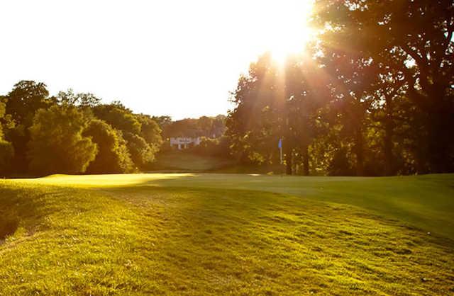 A sunny view of a green at Mere Golf Resort & Spa