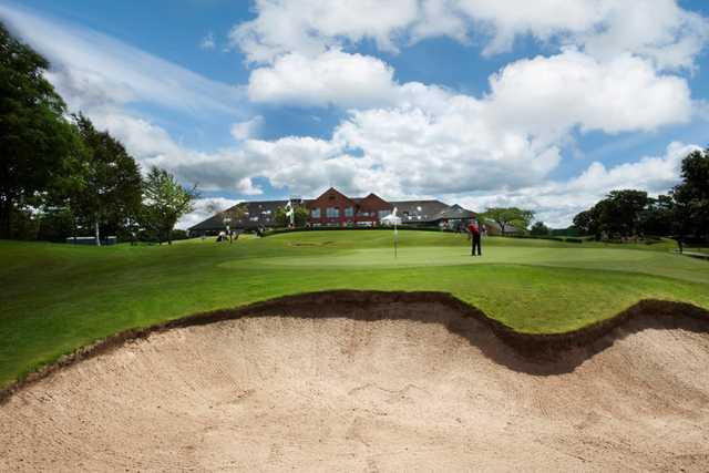 Panoramic view of the clubhouse, 18th green and greenside bunker at Tytherginton Golf Club