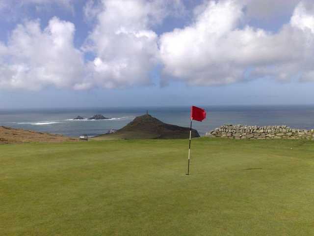 A view of green with water in background at Cape Cornwall Golf & Leisure Resort
