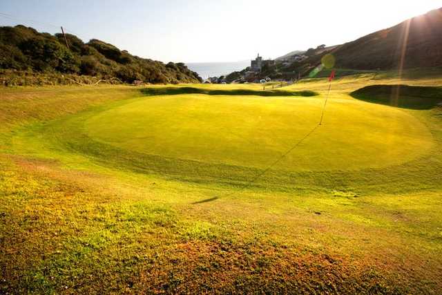 A sunny view of a green at Whitsand Bay Golf Club.
