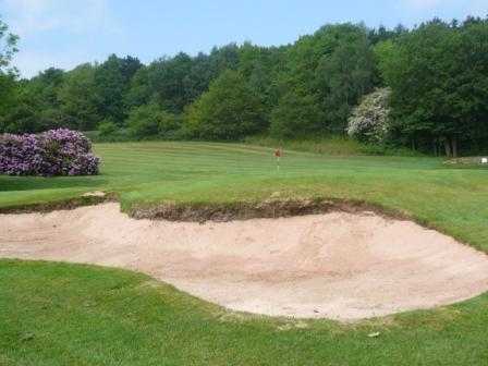 A view of the 4th green guarded by bunker at Chevin Golf Club
