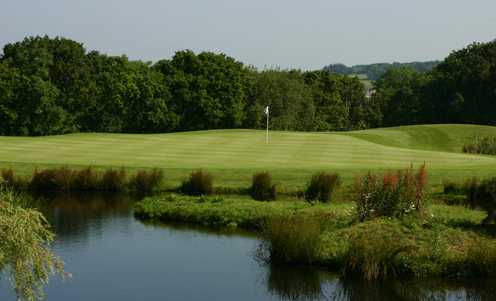 A view over the water of green at Woodbury Park Hotel & Golf Club