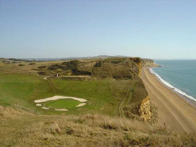 A view of a green surrounded by bunkers at Bridport and West Dorset Golf Club.