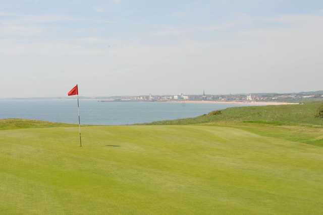 A view of green with water in background at Bridlington Links Golf & Leisure Estate