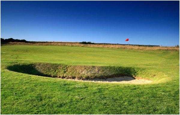 A view of the 16th green protected by bunkers at Flamborough Head Golf Club