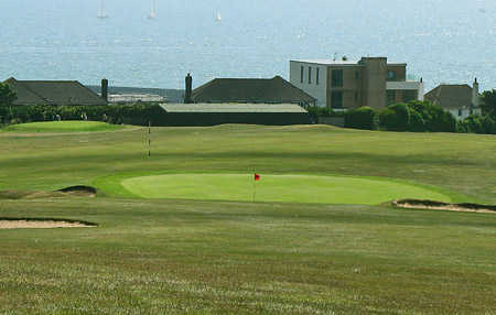 A view hole #18 guarded by bunkers at East Brighton Golf Club