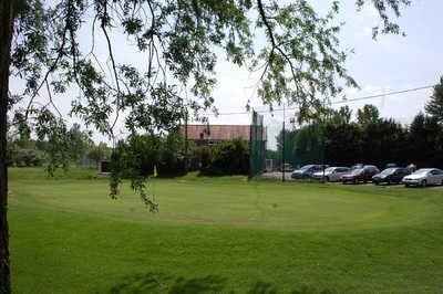 A view of a green with clubhouse and parking area in background at Maldon Golf Club.