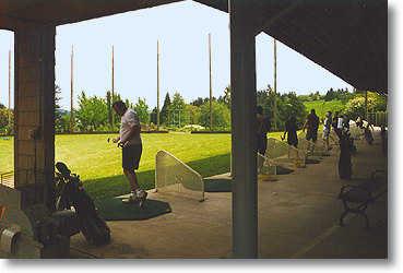 The driving range is covered and lighted. Since the range runs slightly downhill, trampoline greens have been placed at some yardage markers so golfers know where their ball has landed.