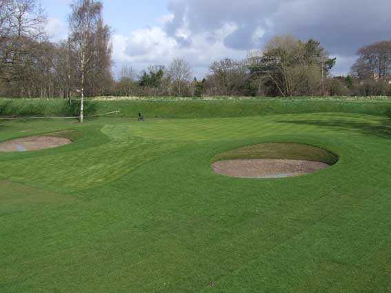 A view of green guarded by bunkers at Didsbury Golf Club
