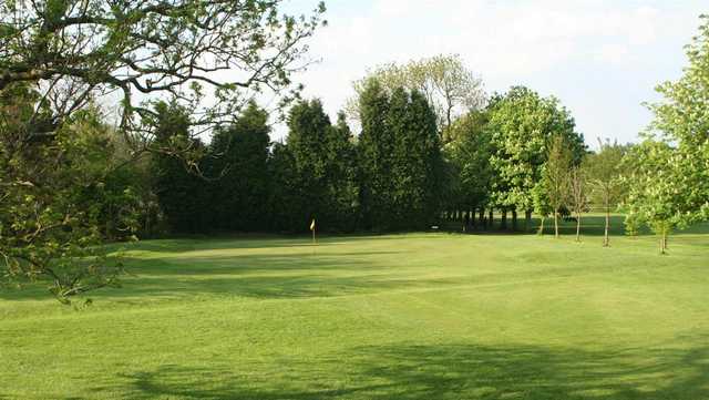 A sunny view of a green at Flixton Golf Club