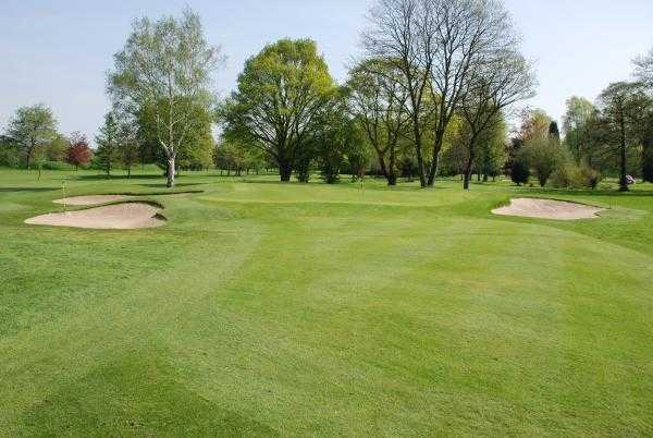 A view of the 12th green protected by sand traps at Northenden Golf Club
