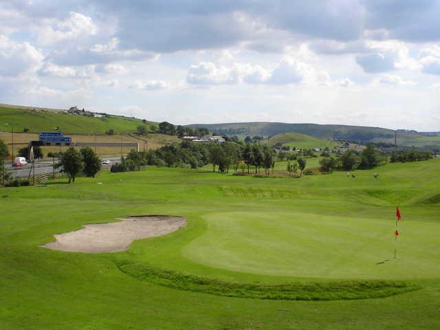 A view of green with sand trap on the left side at Tunshill Golf Club