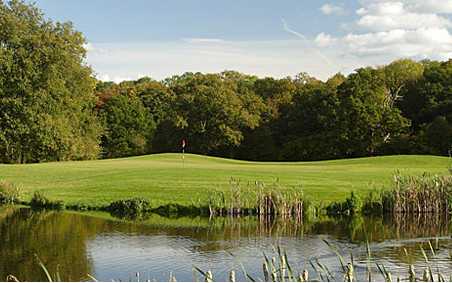 A view over the water of a green at Sherfield Oaks Golf Club