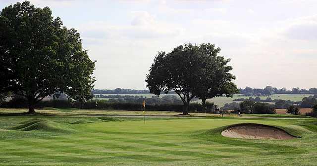 A view of the 13th green with bunker on the right side at Mid Herts Golf Club