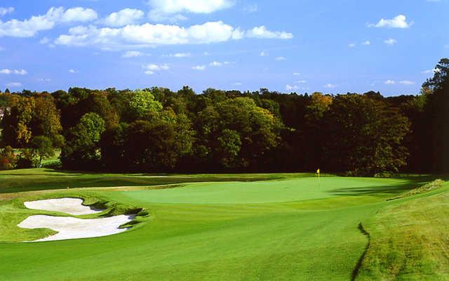 A view of a green guarded by bunkers at Grove Golf Club