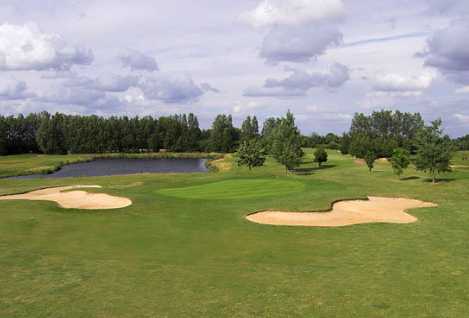 A view of a green with water in background at Chelsfield Lakes Golf Centre