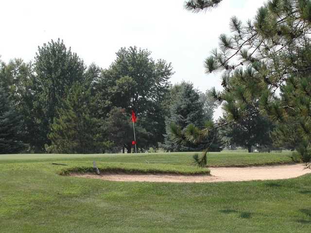 View of a green and bunker from the East course at Fox Prairie Golf Club