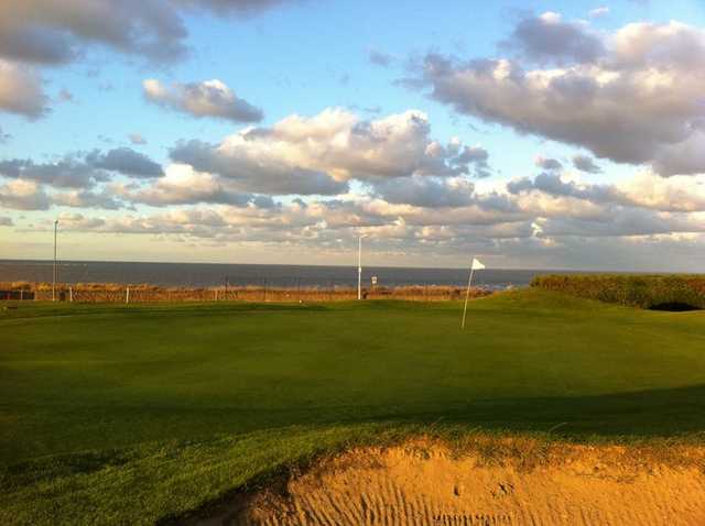 A view of a green with water in background at Westgate & Birchington Golf Club
