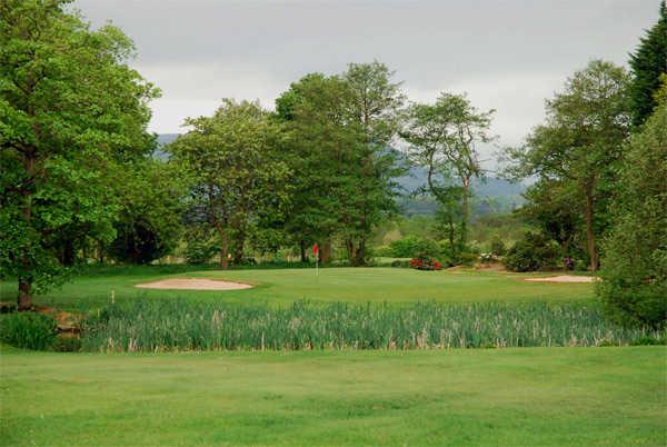 A view of a green flanked by bunkers at Clitheroe Golf Club