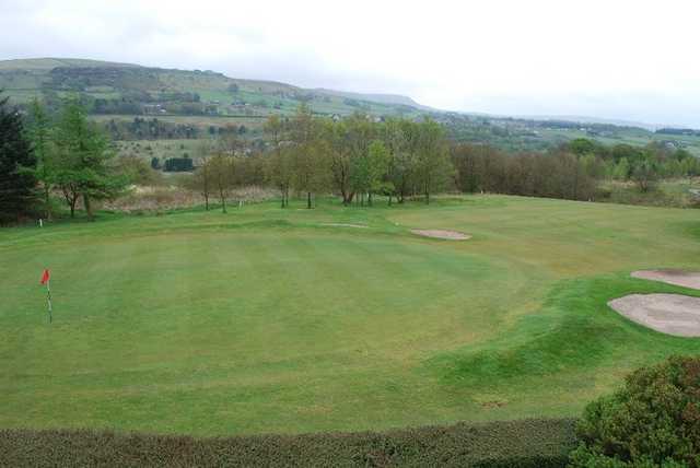 A view of a green guarded by bunkers at Rossendale Golf Club