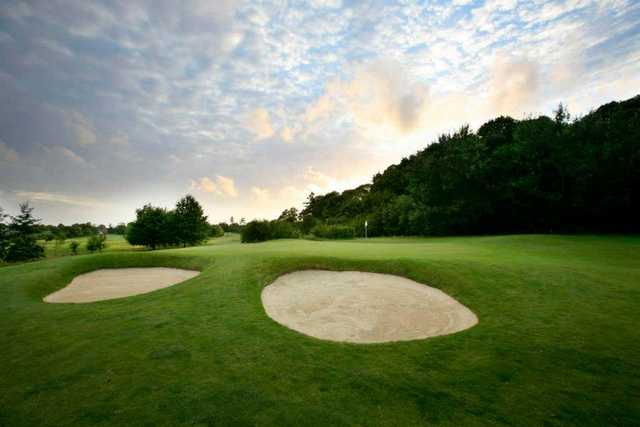 A view of a green guarded by bunkers at Marriott Sprowston Manor Country Club