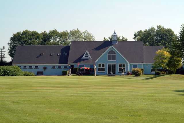 A view of a green and the clubhouse at Richmond Park Golf Club.