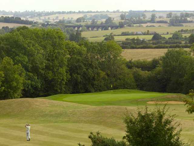 A view of a green guarded by bunker at Hellidon Lakes Golf & Spa Hotel