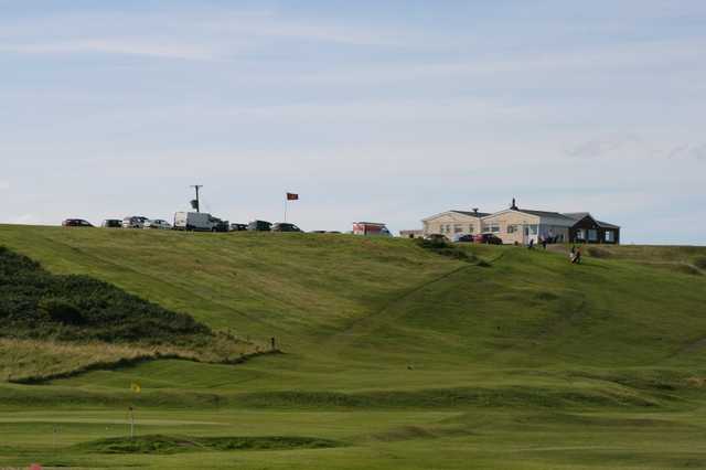 A view of a green and the clubhouse in backgound at Warkworth Golf Club