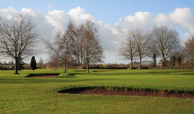 A view of  a green guarded by bunkers at Fosseway Golf Club
