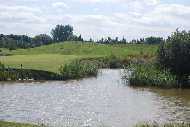A view over the water of green #9 at Kingswood Golf Centre